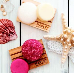 Colorful Naples Soap Company soap bars set among seashells